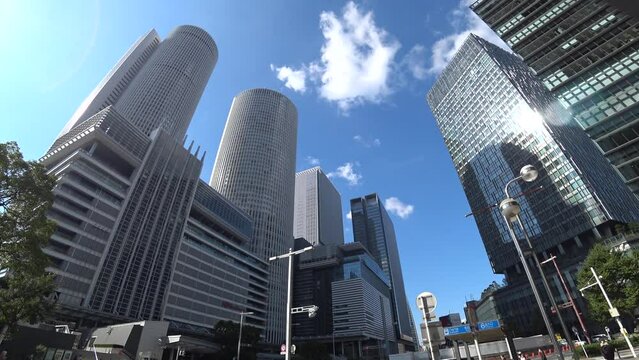 NAOGYA, JAPAN - OCTOBER 2022 : View of NAGOYA STATION and office buildings in sunny daytime. Travel, tourism, business and transportation concept video.