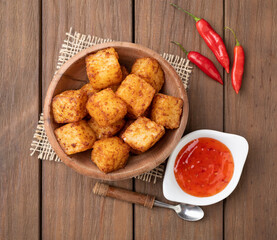 Tapioca dice, typical northeast brazilian food with chilli pepper syrup over wooden table
