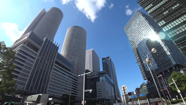 NAOGYA, JAPAN - OCTOBER 2022 : Time lapse shot of NAGOYA STATION and office buildings in sunny daytime. Business, transportation, travel and tourism concept video.
