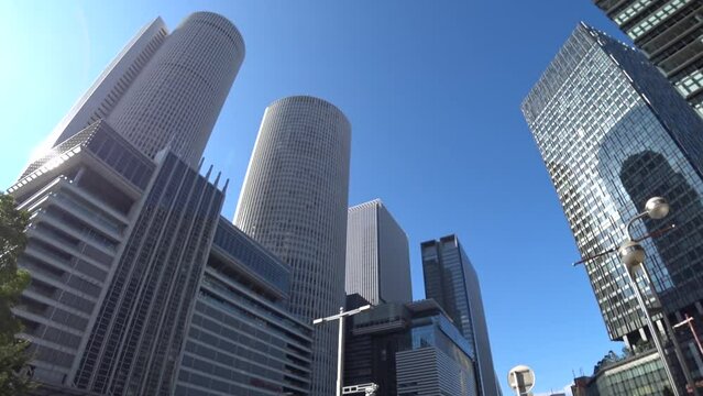 NAOGYA, JAPAN - OCTOBER 2022 : View of NAGOYA STATION and office buildings in daytime. Time lapse shot. Travel, tourism, business and transportation concept video.