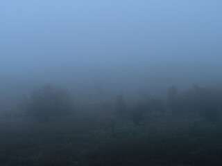 Obraz na płótnie Canvas Foggy outdoor scene with hills and trails
