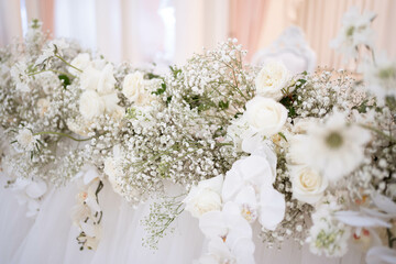 Main table at a wedding reception with beautiful fresh flowers and candles.