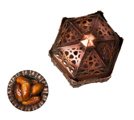 Ornamental dark Arabic lantern and plate with sugar and dates