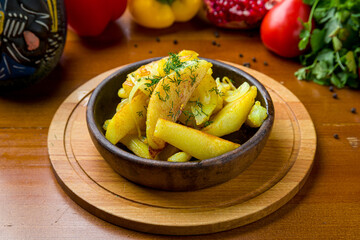 fried potatoes with onions on wooden table