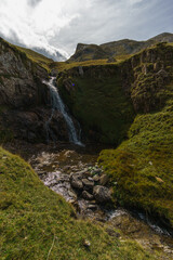 Fototapeta na wymiar beautiful waterfall of small creek in Pyrenees Mountains, Col du Pourtalet, Nouvelle-Aquitaine France