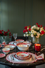 luxury designed dinner table with red and white plates