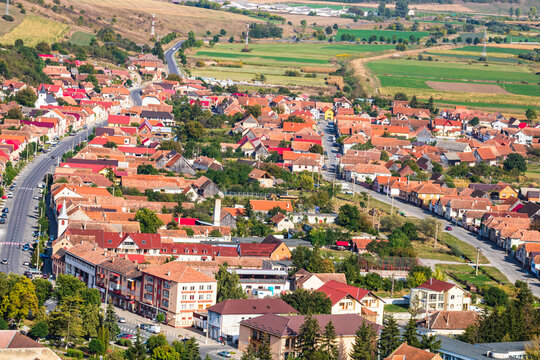Aerial view of the town center with hills, buildings, streets, vegetation and surroundings in Rupea, Romania, 2021