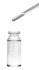 A drop of liquid falls from a glass pipette