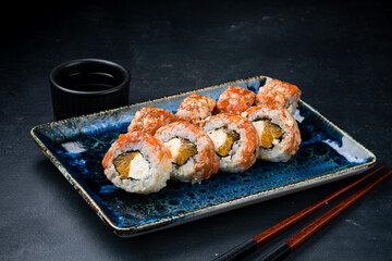 Japanese kitchen set of sushi rolls with salmon, shrimp, cream cheese and orange.
