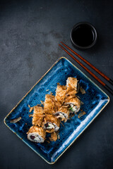 Sushi rolls with tuna, cream cheese, cucumber in dry shavings of tuna.