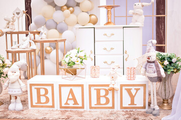 white and gold themed baby shower decor, teddy bears and santa claus