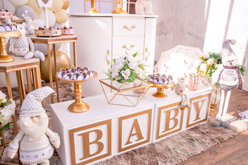 white and gold themed baby shower decor, teddy bears and santa claus