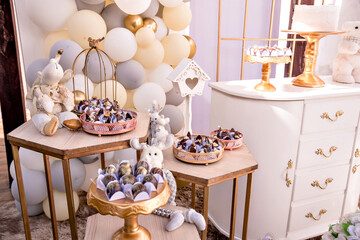 white and gold themed baby shower decor, teddy bears and santa claus