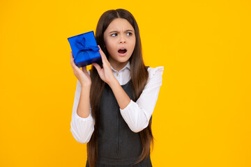 Shocked surprised teenager girl. Teenager kid with present box. Teen girl giving birthday gift. Present, greeting and gifting concept.