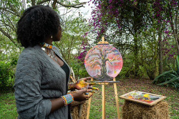 young female artist proudly displaying her work