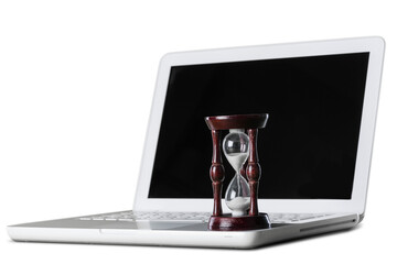 Hourglass and laptop concept for time slipping away