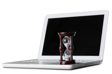 Hourglass and laptop concept for time slipping away
