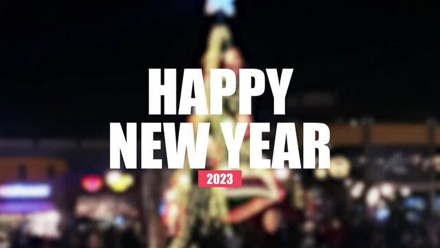 Happy new year cinematic text animation with a Christmas tree behind.