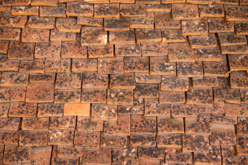 Medieval tiled roof made of handmade clay tiles as texture or background