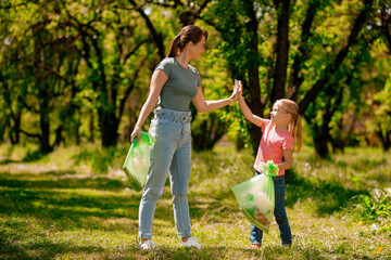 Cute family gathering garbage in the park