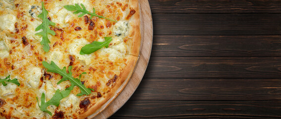 Four cheese pizza on a wooden board. Banner