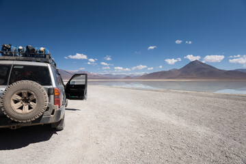 adventure in a 4x4 car, travel through latin america with landscape of an island with mountains in...