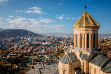Aerial skyline with downtown district and Holy Trinity church dome or Tsminda Sameba Cathedral - 555270072