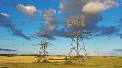 Kyiv Region, Ukraine - 25.08.2022: Power line near Kyiv. Towers and wires of power lines. Power line in the field of colors of the flag of Ukraine