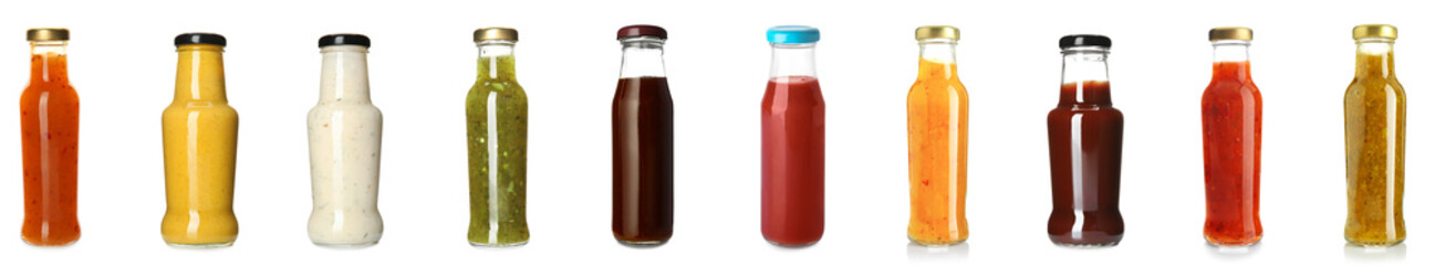 Group of delicious sauces in bottles on white background