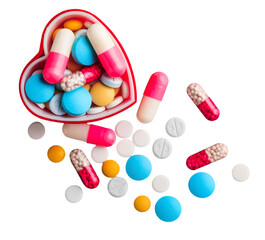 Colorful medical pills and capsules in heart shaped box