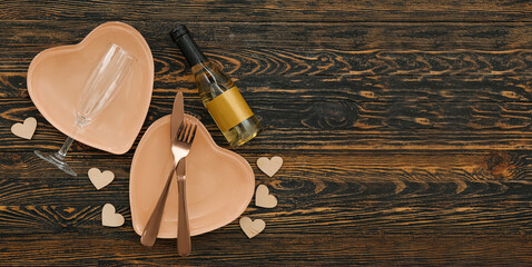 Table setting for Valentine's Day on dark wooden background with space for text