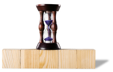 Hourglass on stack wooden cube