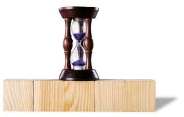 Hourglass on stack wooden cube