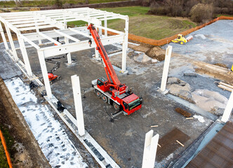 Prefabricated concrete skeleton frame building being constructed, building site, aerial view