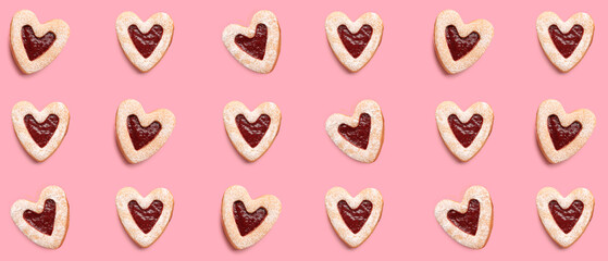 Many tasty cookies in shape of hearts on pink background. Pattern for Valentine's Day