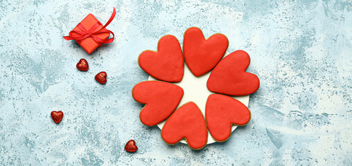 Tasty heart-shaped cookies for Valentines Day and gift on light blue background, top view