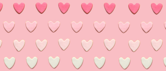 Many tasty cookies in shape of hearts on pink background. Pattern for Valentine's Day