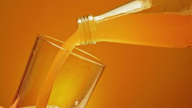Orange juice is poured from a bottle, thirst and desire to get drunk