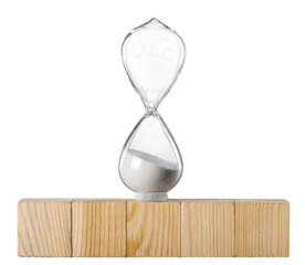 Hourglass on stack wooden cube