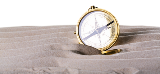 Gold compass on the sand