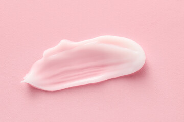 Sample of moisturizing cream on pink background