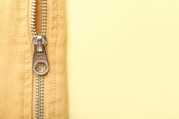 Fototapeta na wymiar Clothes with zipper on yellow background