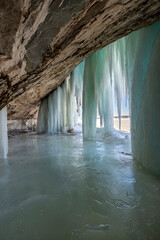 water flowing into the water in an extreme winter causes ice curtains to form on a Lake Superior Island