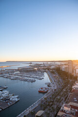 People walking on the Paseo Maritimo in the touristic city of Alicante in Spain in 2022.