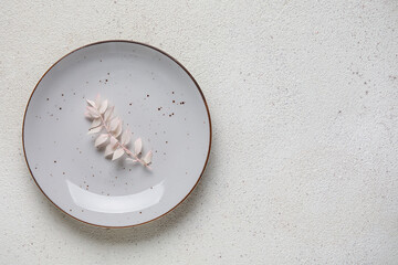 Plate with floral decor on grey background