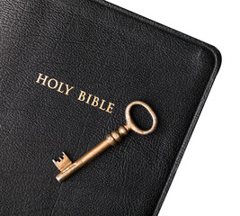 Old metal key on Bible book