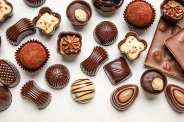 Chocolate bars and candies on white background