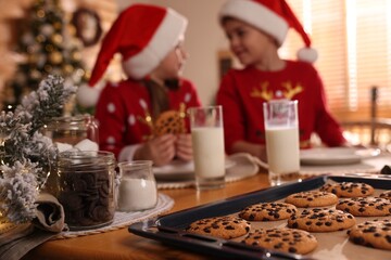 Cute little children with delicious Christmas cookies at home, focus on pastry