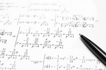 Sheet of paper with mathematical formulas and pen, closeup