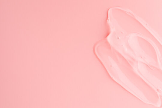 Sample of transparent gel on pink background, top view. Space for text © New Africa